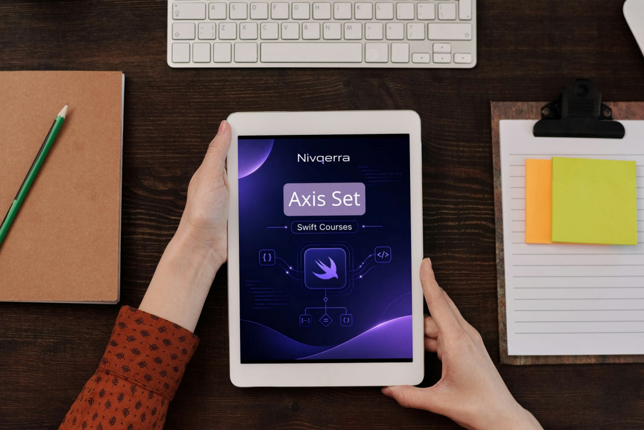 Person holding a tablet displaying Nivigerra software on a desk with a keyboard and stationery items.