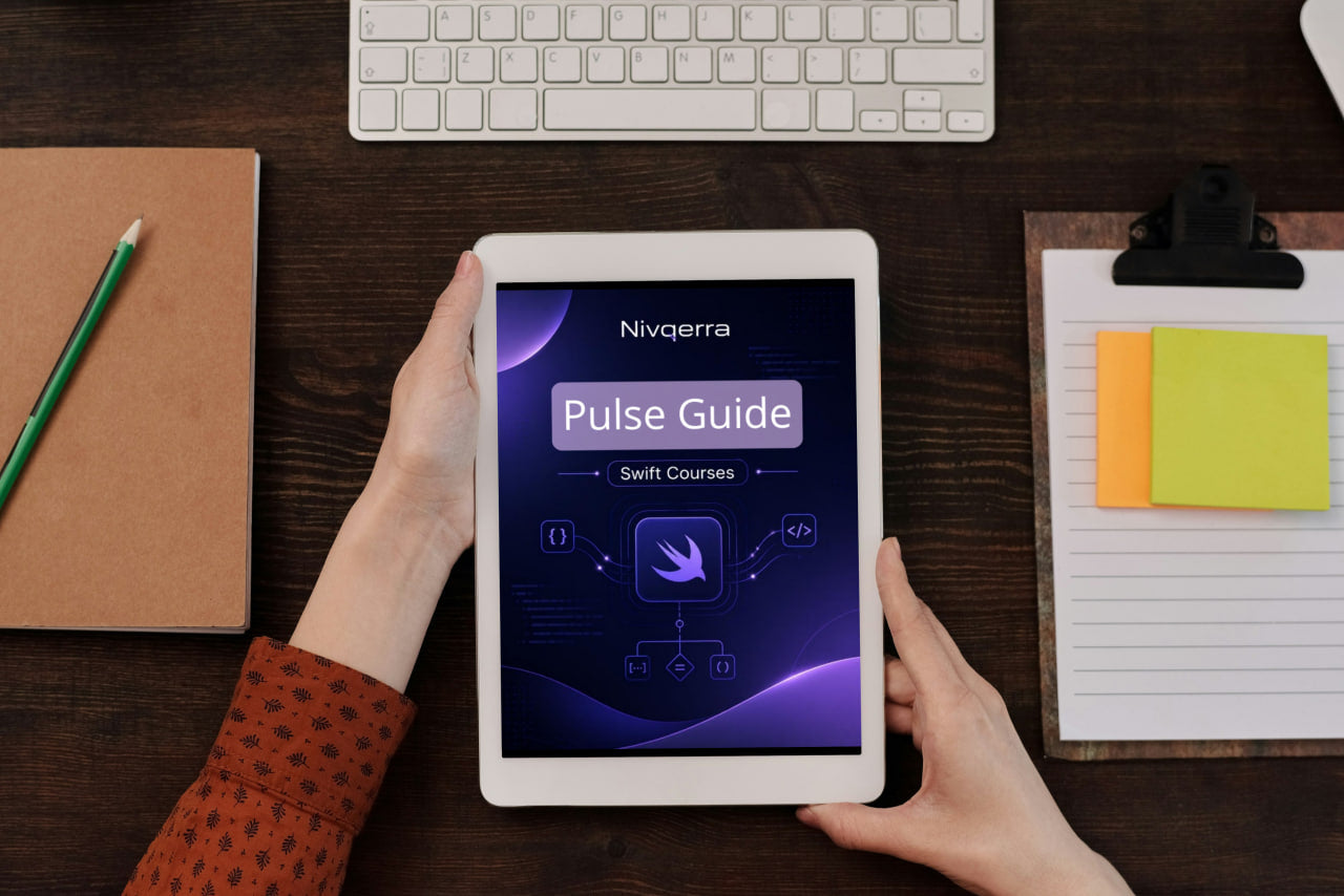 Person holding a tablet displaying the Nivigerra Pulse Guide on a desk with a keyboard and stationery items.